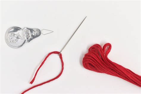 how to thread an embroidery needle and the art of patience